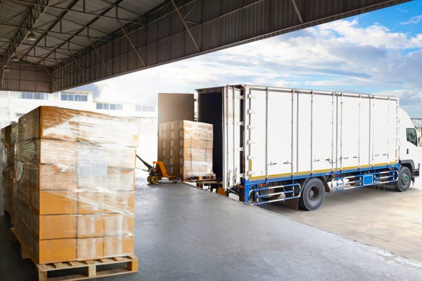 Container Trucks Parked Loading Package Boxes Pallets at Warehouse Dock. Supply Chain, Distribution Warehouse Shipping, Supplies Shipment Boxes. Freight Truck Logistic, Cargo Transport.